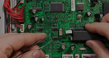 operators hands working on an electronic board